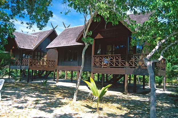 Timber resort buildings among the trees at Mataking - The Reef Dive Resort